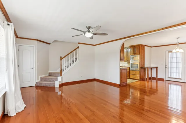 a view of an entryway with wooden floor and a ceiling fan
