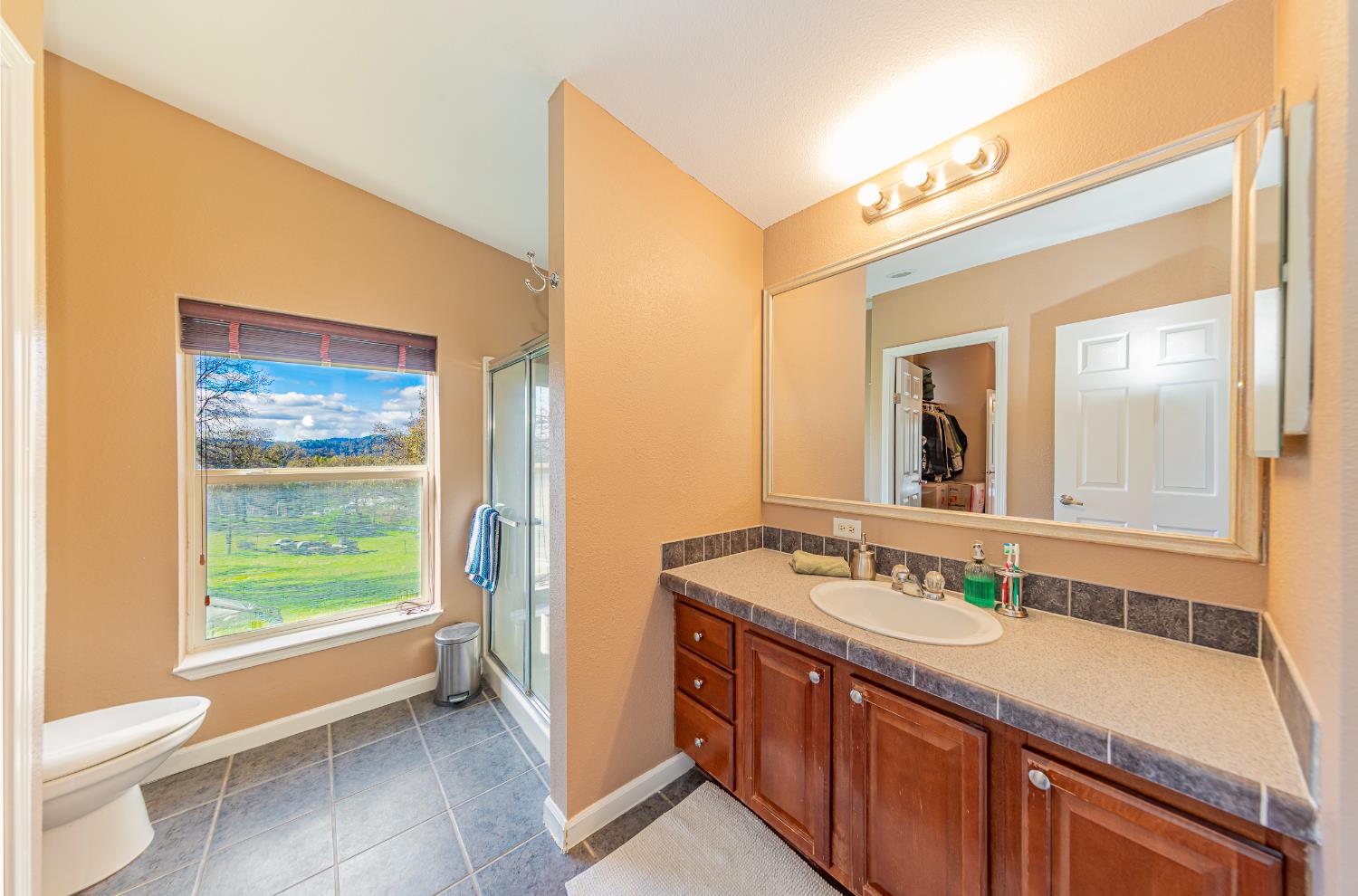 3335 Wildcat Road Mariposa, CA 95338 - Photo 33 of 48 a bathroom with a granite countertop sink mirror and a bathtub