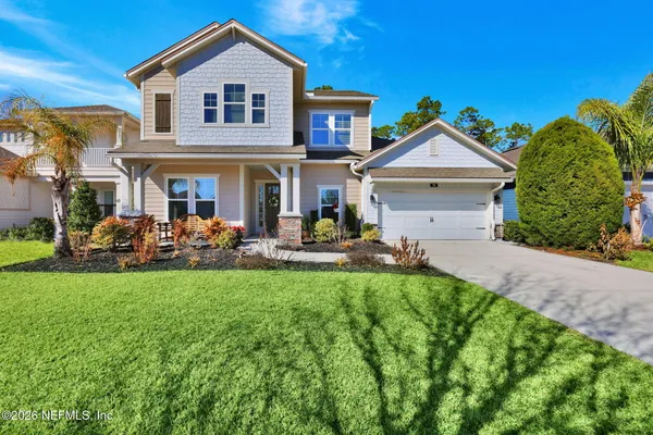 a front view of a house with a yard and porch
