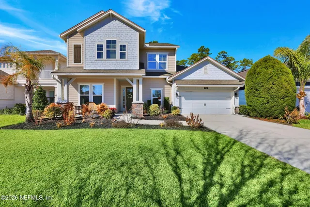 a front view of a house with a yard and porch