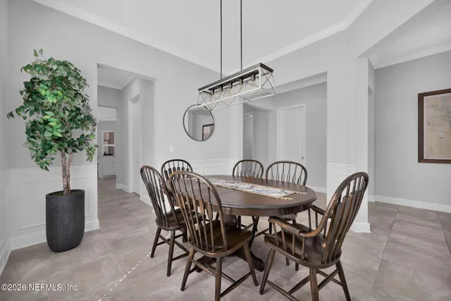 a living room with furniture and a view of kitchen