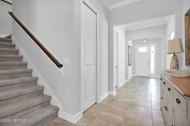 a kitchen with stainless steel appliances a stove a sink a refrigerator and chairs
