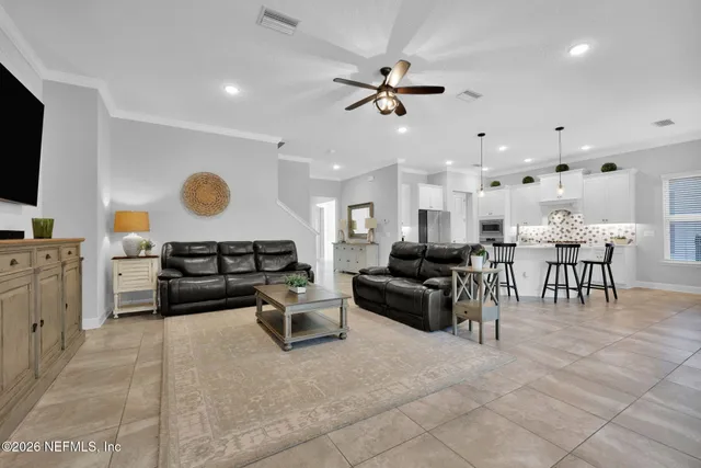 a spacious bedroom with a bed and a flat screen tv