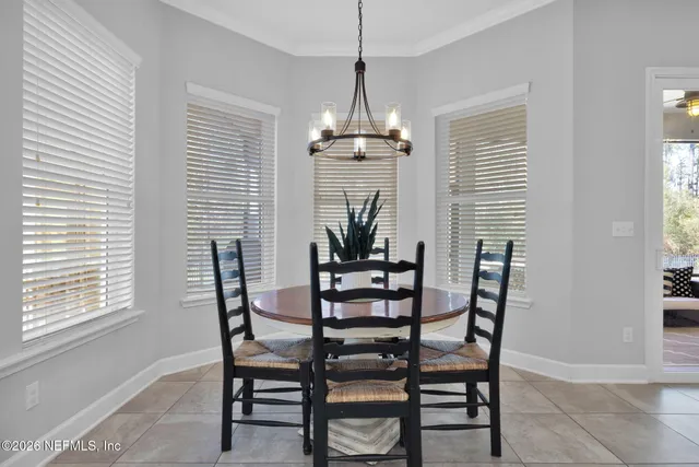 a bedroom with furniture and a large window