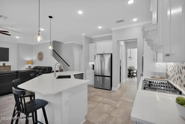 a spacious bedroom with a bed and a lamp