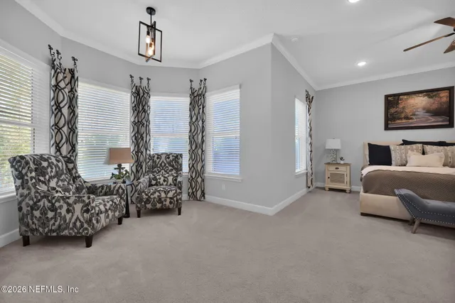 a living room with furniture a window and a potted plant