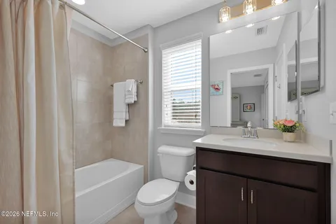 an aerial view of a house with a garden and lake view