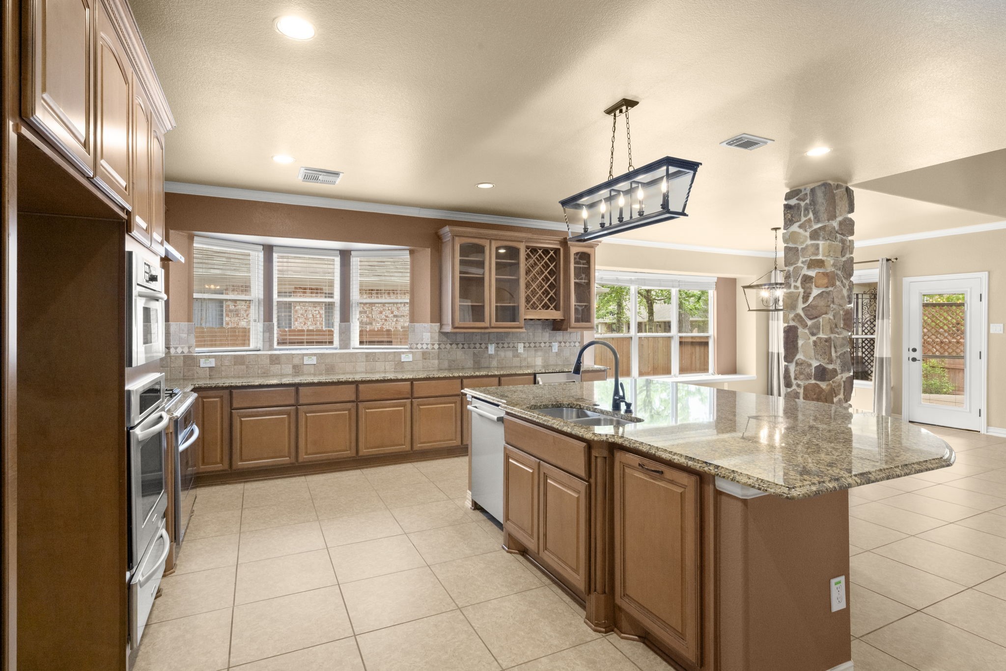 110 David Forest Lane Conroe, TX 77384 - Photo 13 of 35 a kitchen with a sink stove and cabinets