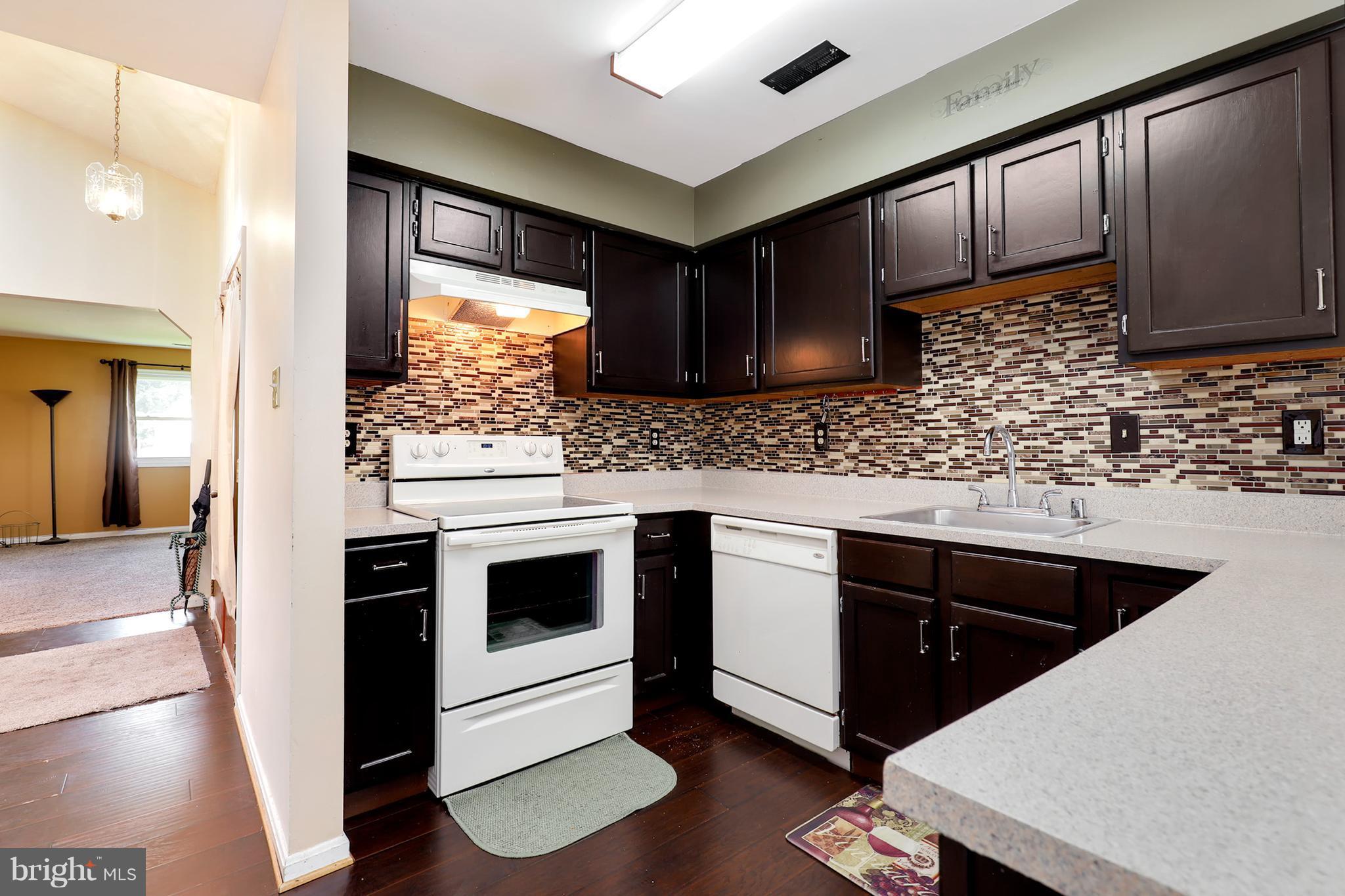 10604 Gator Court Clinton, MD 20735 - Photo 11 of 24 a kitchen with stainless steel appliances kitchen island granite countertop a sink stove and refrigerator