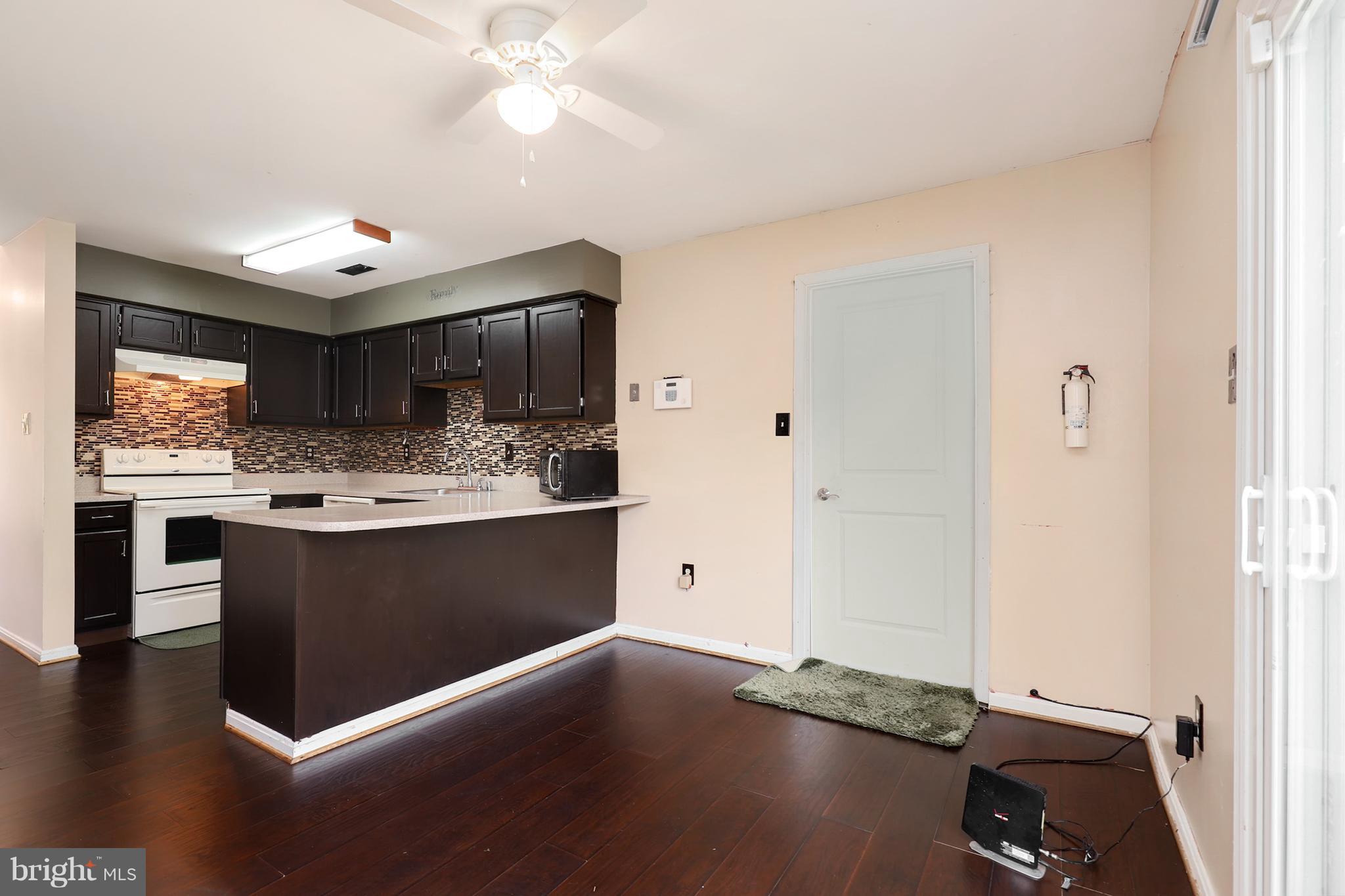 10604 Gator Court Clinton, MD 20735 - Photo 13 of 24 a kitchen with stainless steel appliances granite countertop a sink window and cabinets