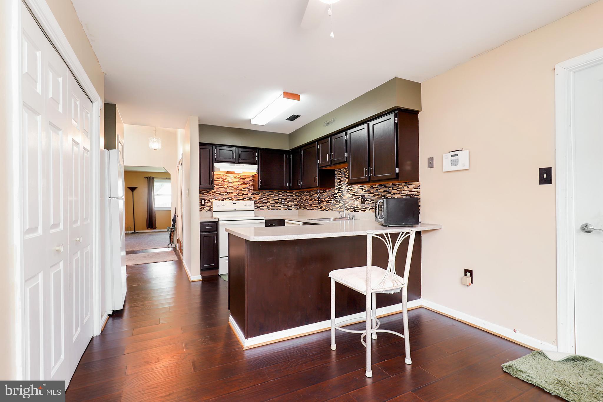 10604 Gator Court Clinton, MD 20735 - Photo 14 of 24 a kitchen with stainless steel appliances kitchen island granite countertop a refrigerator and a stove top oven