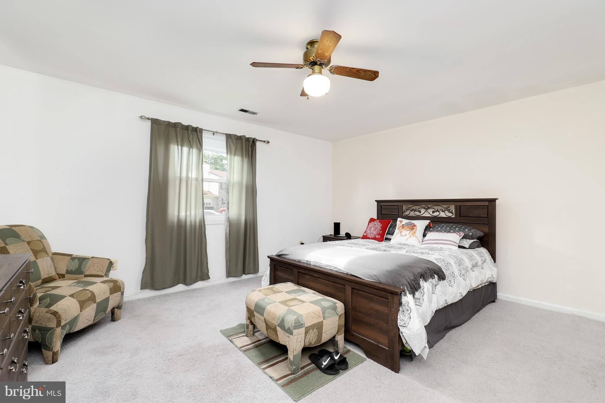 10604 Gator Court Clinton, MD 20735 - Photo 20 of 24 a bedroom with a bed and a chandelier