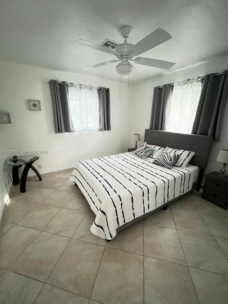 3324 Lakeview Boulevard Delray Beach, FL 33445 - Photo 20 of 36 a bedroom with a bed and window