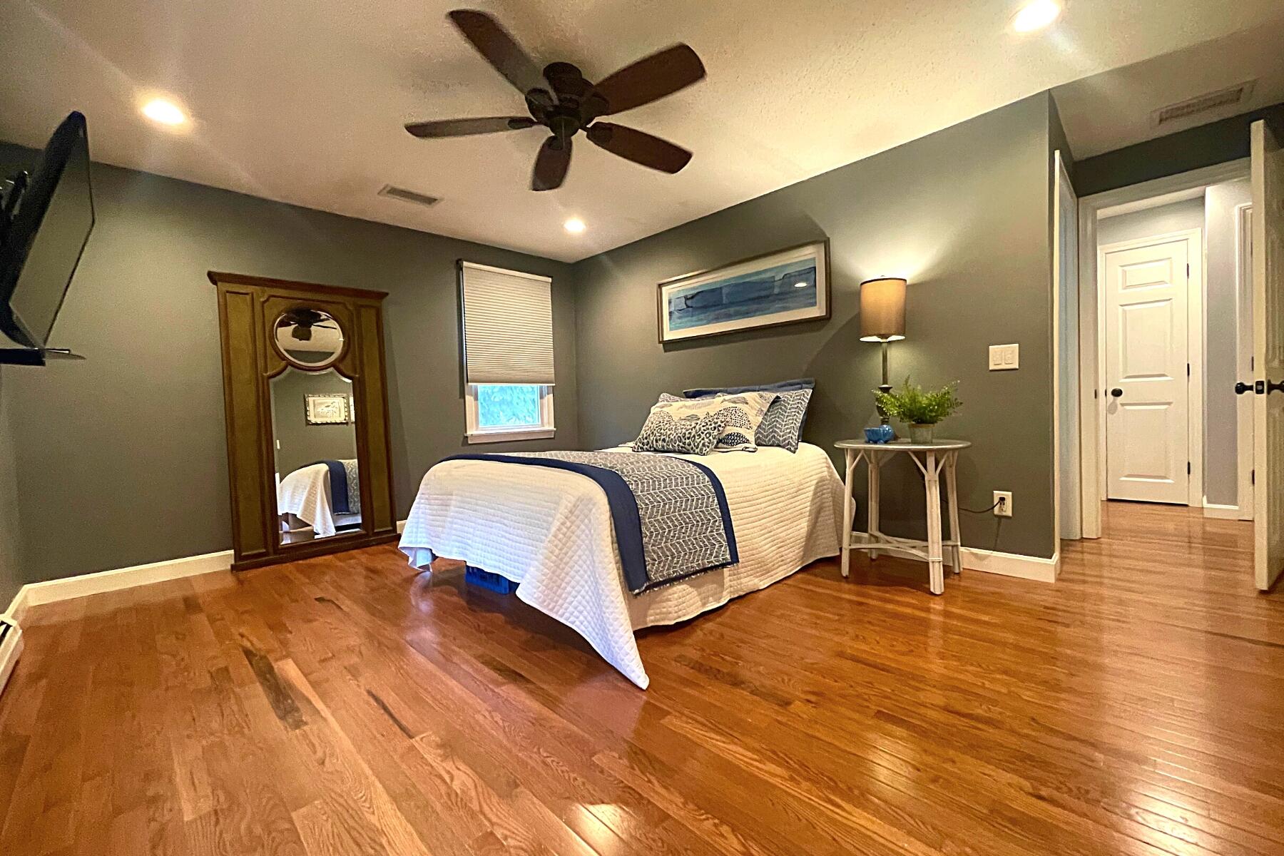 263 Cammett Road Marstons Mills, MA 02648 - Photo 16 of 33 a bedroom with a bed and wooden floor