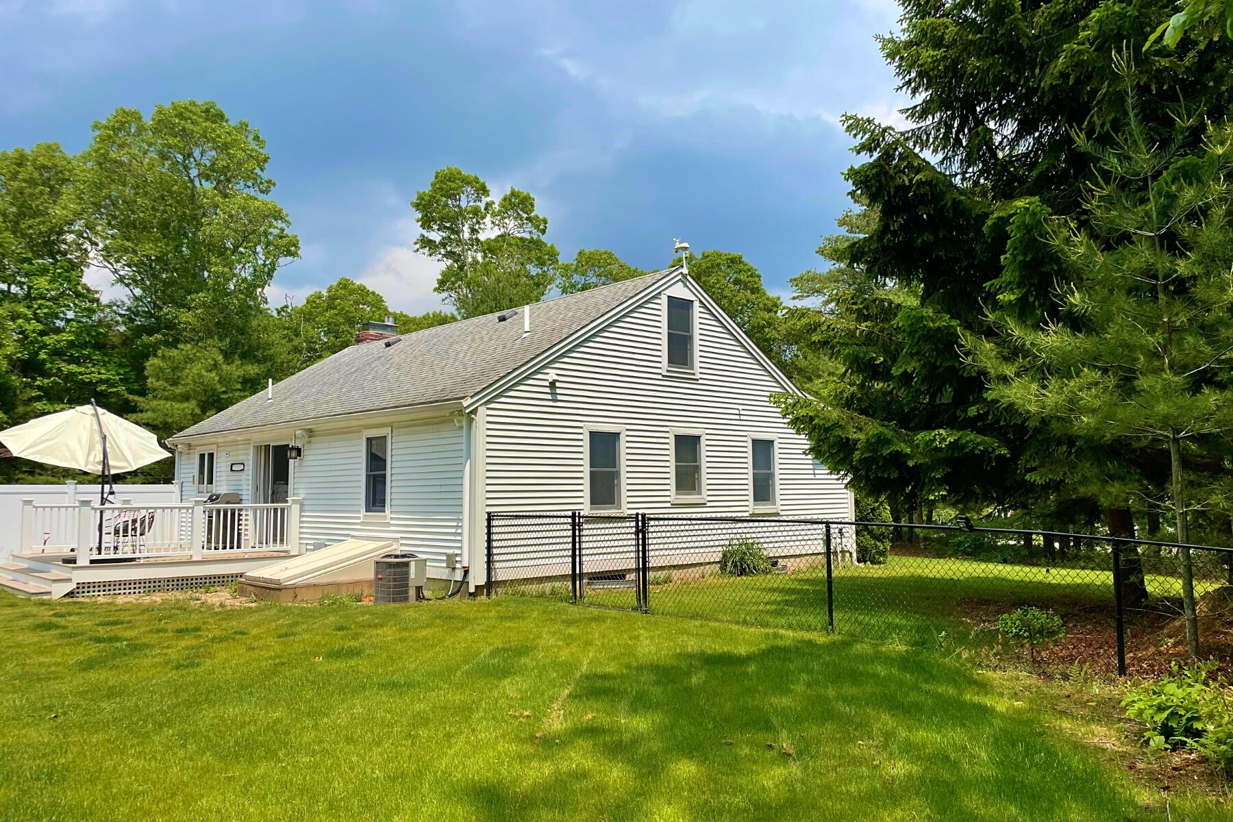 263 Cammett Road Marstons Mills, MA 02648 - Photo 24 of 33 a view of a house with a yard porch and sitting area
