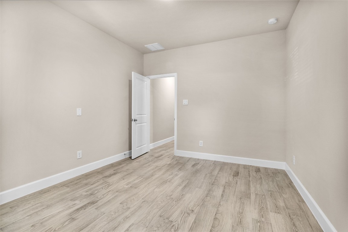 496 Golden Street, Unit A Willis, TX 77378 - Photo 14 of 26 a view of an empty room with wooden floor