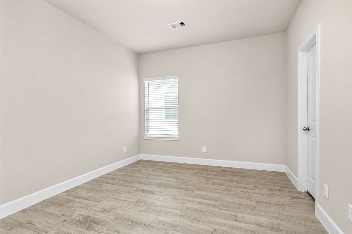 496 Golden Street, Unit A Willis, TX 77378 - Photo 18 of 26 wooden floor in an empty room