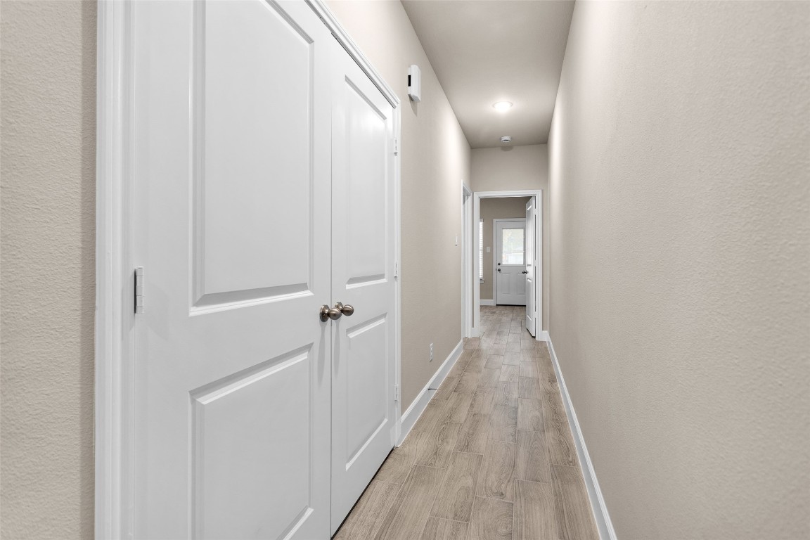 496 Golden Street, Unit A Willis, TX 77378 - Photo 20 of 26 a view of a hallway with wooden floor