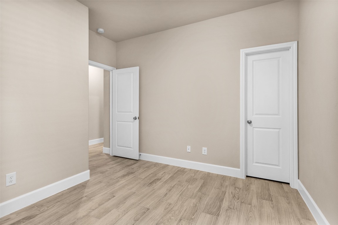 496 Golden Street, Unit A Willis, TX 77378 - Photo 21 of 26 an empty room with wooden floor and closet
