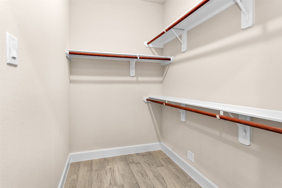 496 Golden Street, Unit A Willis, TX 77378 - Photo 23 of 26 a view of closet with wooden floor