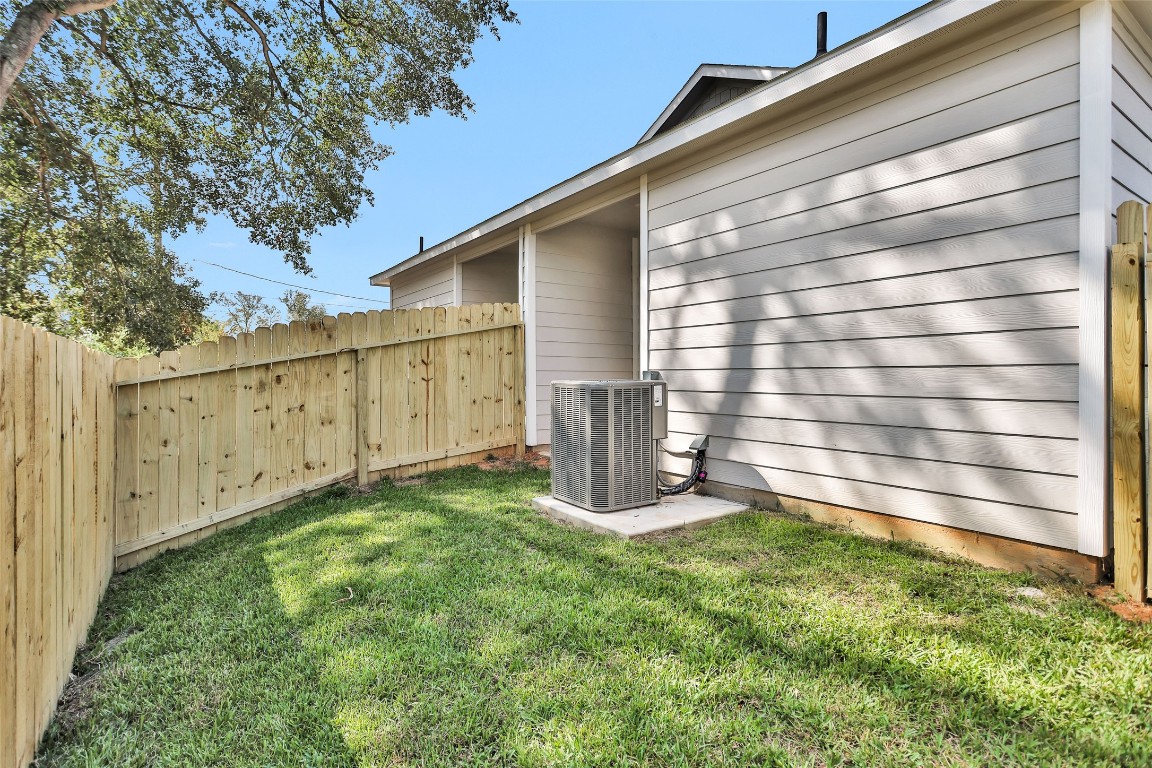 496 Golden Street, Unit A Willis, TX 77378 - Photo 24 of 26 a view of a backyard with wooden fence