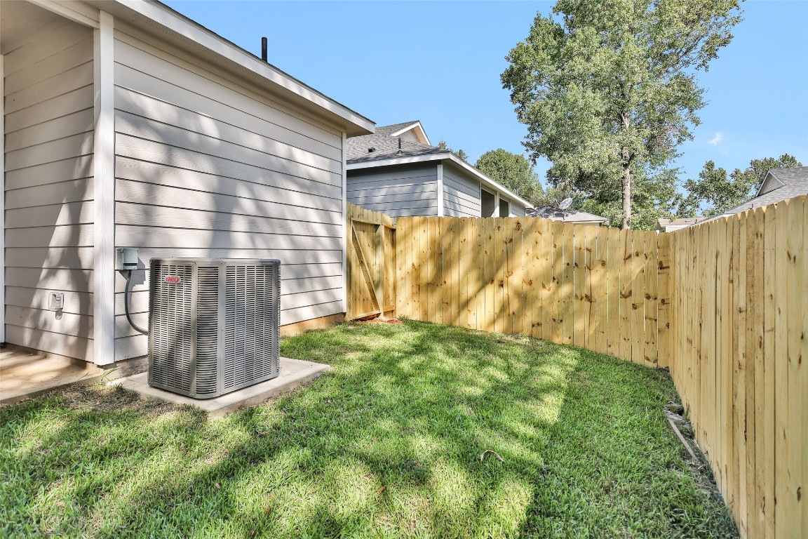 496 Golden Street, Unit A Willis, TX 77378 - Photo 25 of 26 a view of a back yard of the house