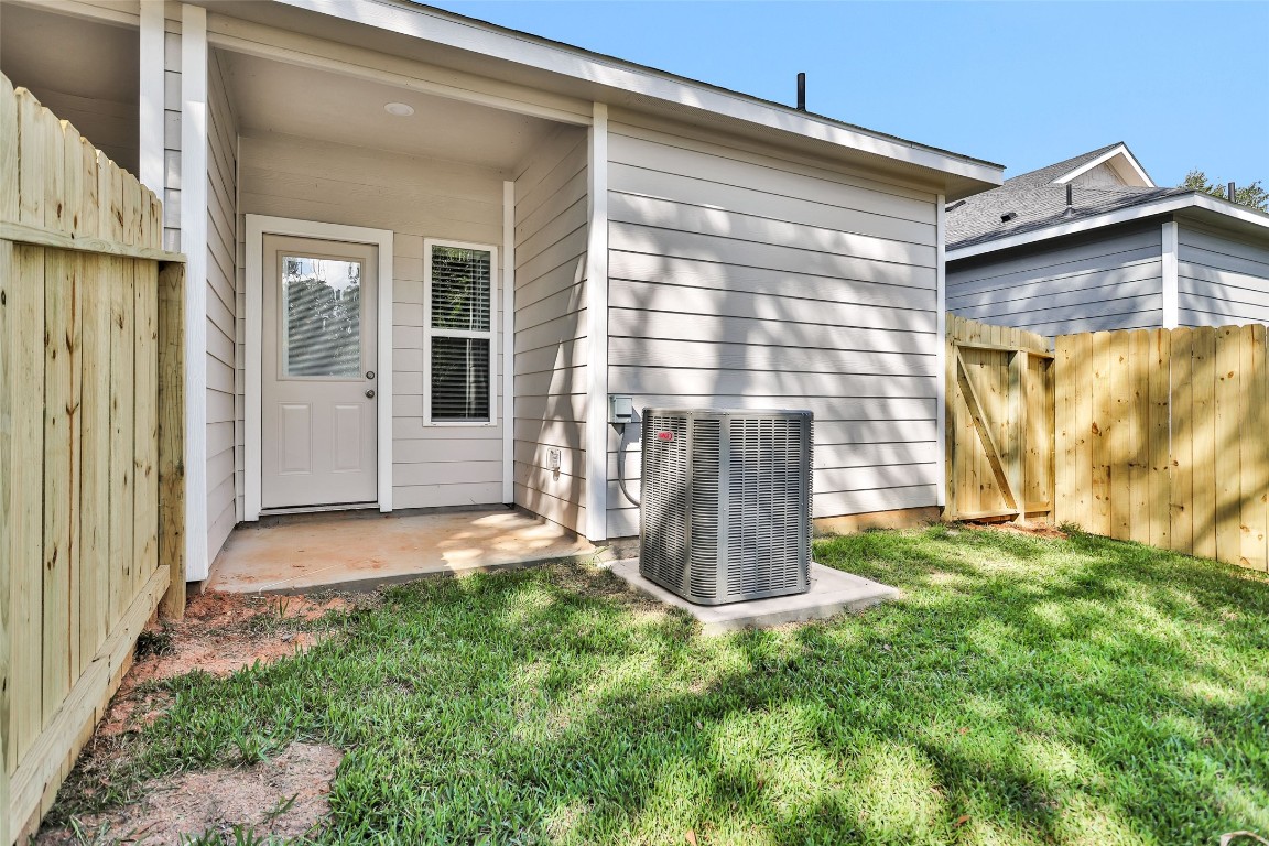 496 Golden Street, Unit A Willis, TX 77378 - Photo 26 of 26 a view of a back yard of the house