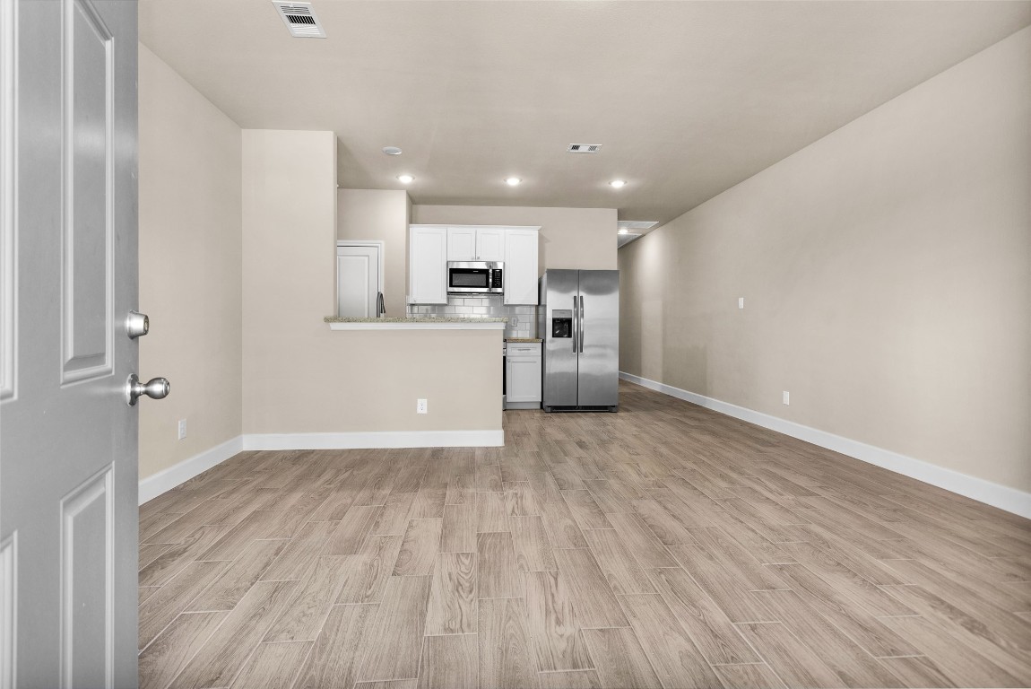 496 Golden Street, Unit A Willis, TX 77378 - Photo 4 of 26 a view of a kitchen with a sink and a refrigerator