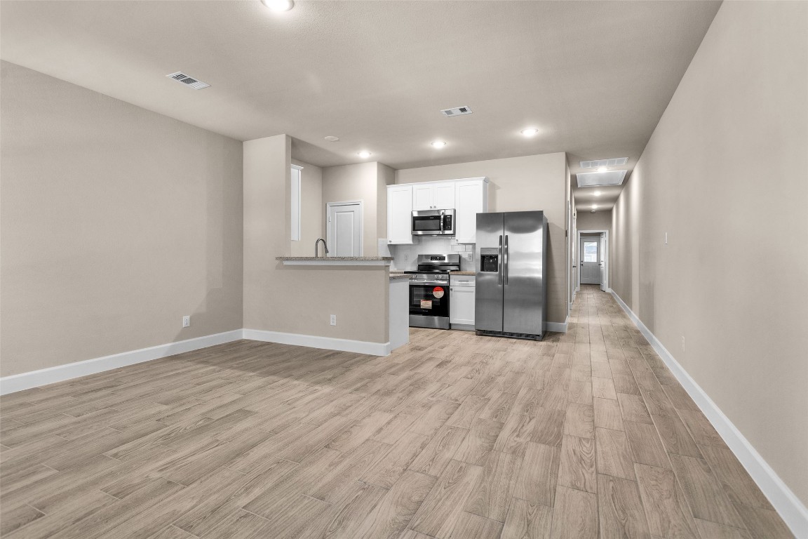 496 Golden Street, Unit A Willis, TX 77378 - Photo 5 of 26 a view of kitchen with wooden floor and refrigerator