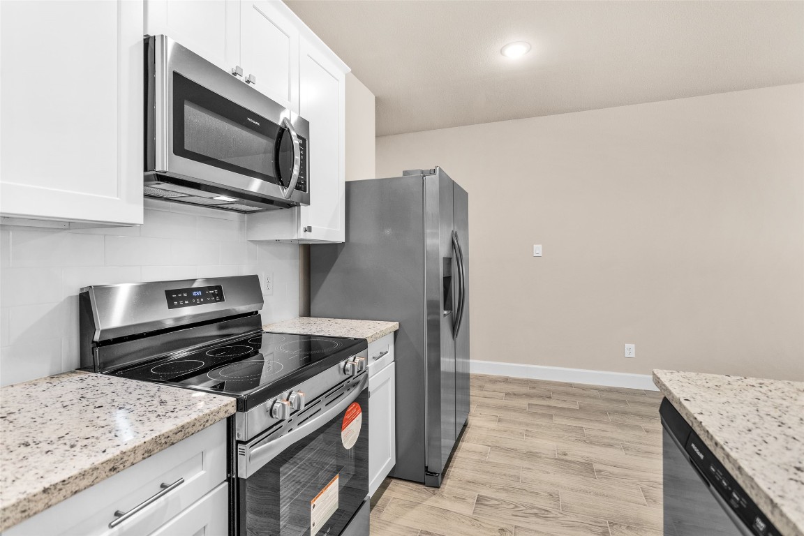496 Golden Street, Unit A Willis, TX 77378 - Photo 8 of 26 a kitchen with a stove and a microwave