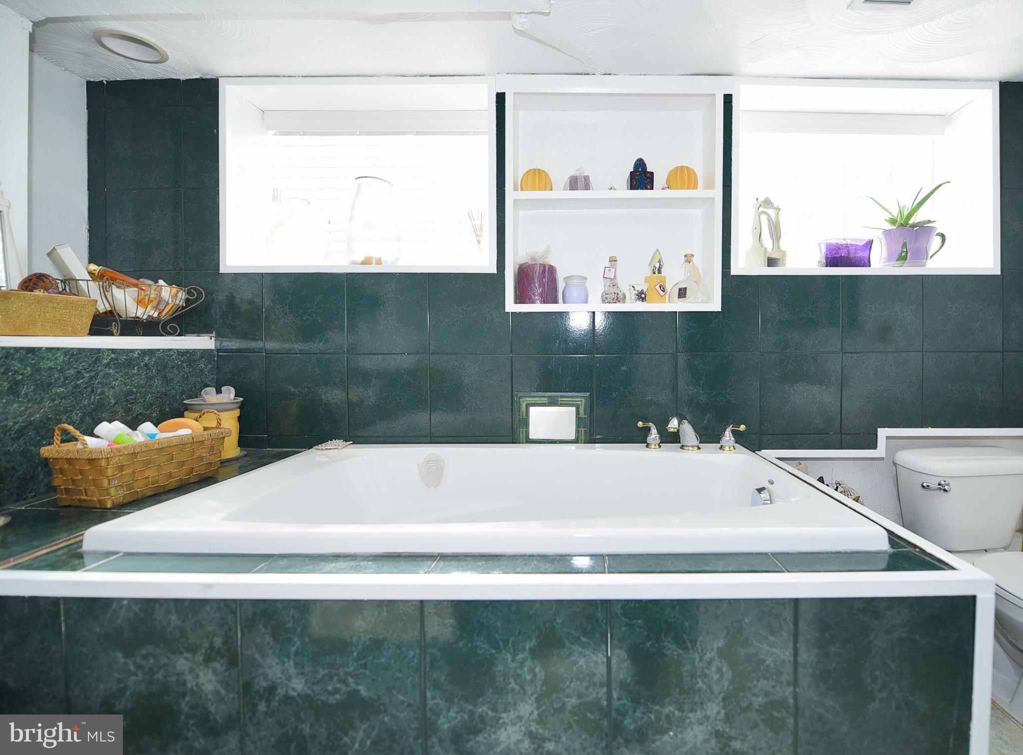 908 Bardswell Road Baltimore, MD 21228 - Photo 21 of 29 a bathroom with a bathtub and a sink