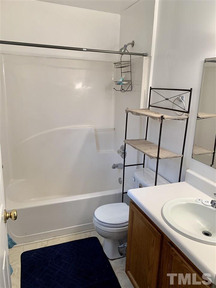 1117 Thelonious Drive Raleigh, NC 27610 - Photo 11 of 25 a bathroom with a sink a toilet and shower