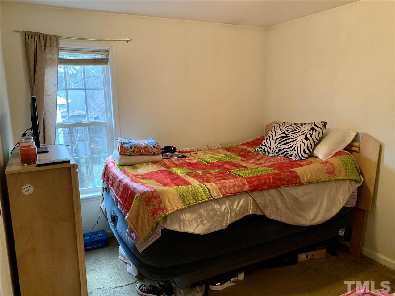 1117 Thelonious Drive Raleigh, NC 27610 - Photo 12 of 25 a bedroom with a bed and wooden floor