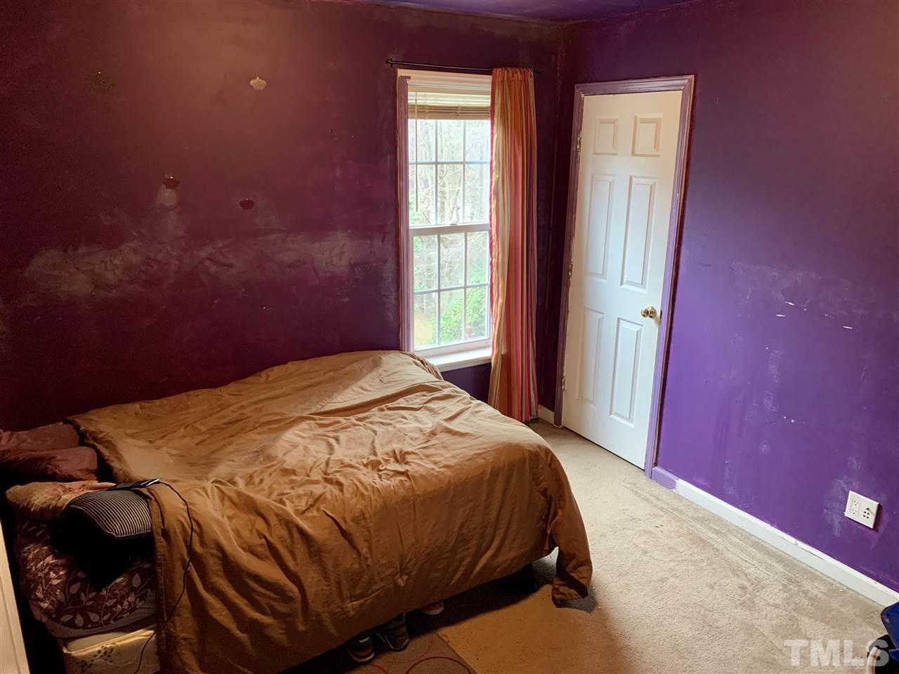 1117 Thelonious Drive Raleigh, NC 27610 - Photo 13 of 25 a bedroom with a bed and a window