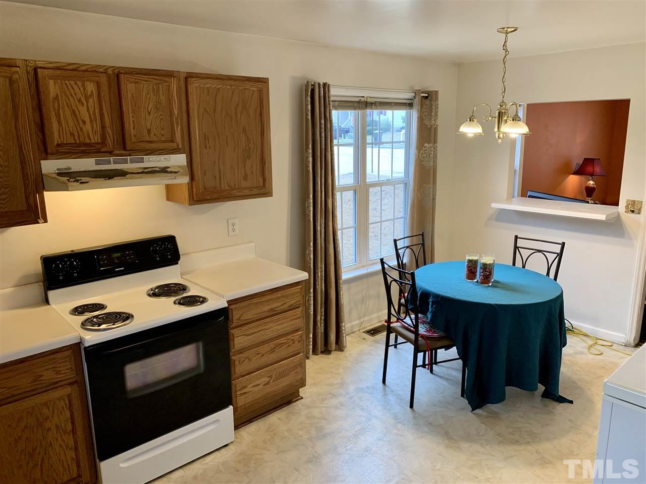 1117 Thelonious Drive Raleigh, NC 27610 - Photo 15 of 25 a kitchen with a stove a sink and a refrigerator