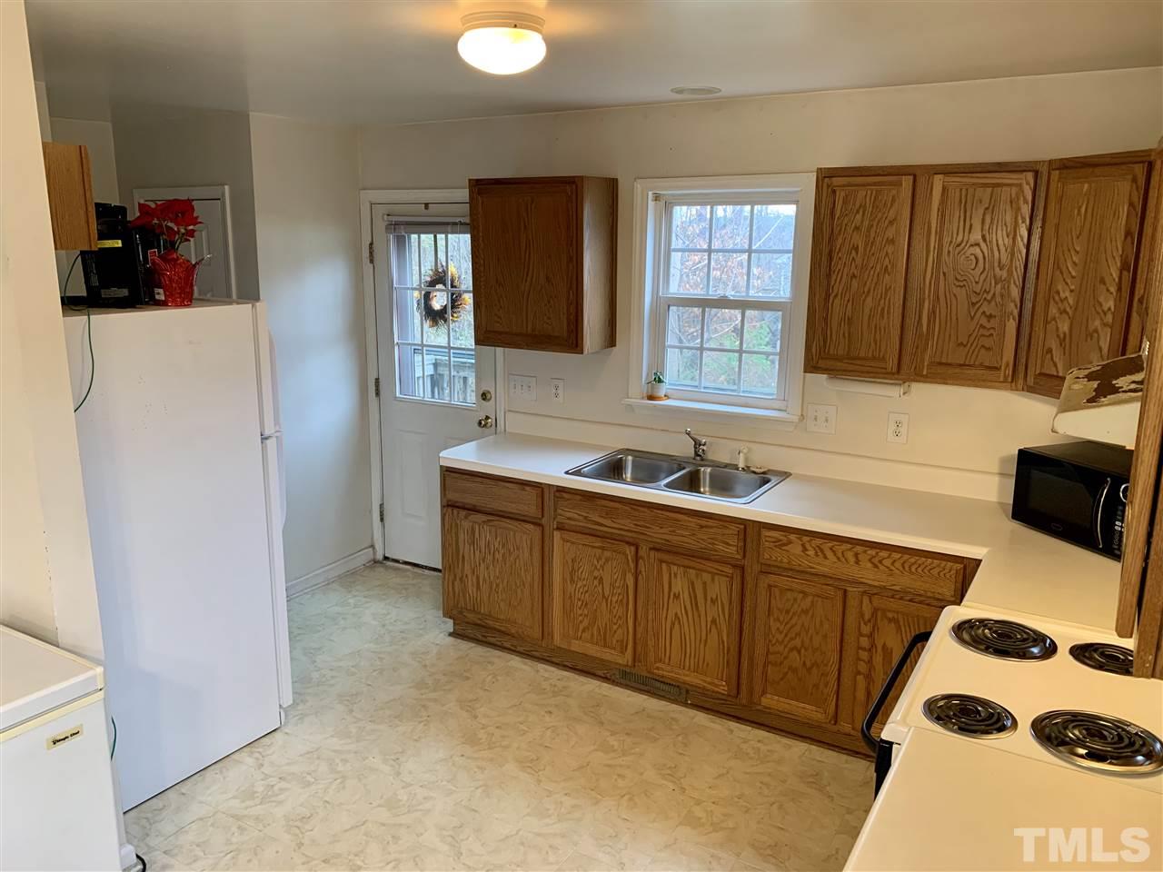 1117 Thelonious Drive Raleigh, NC 27610 - Photo 16 of 25 a kitchen with stainless steel appliances granite countertop a sink stove and refrigerator