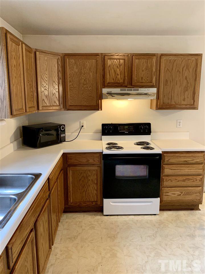 1117 Thelonious Drive Raleigh, NC 27610 - Photo 18 of 25 a kitchen with stainless steel appliances a stove a sink and a microwave