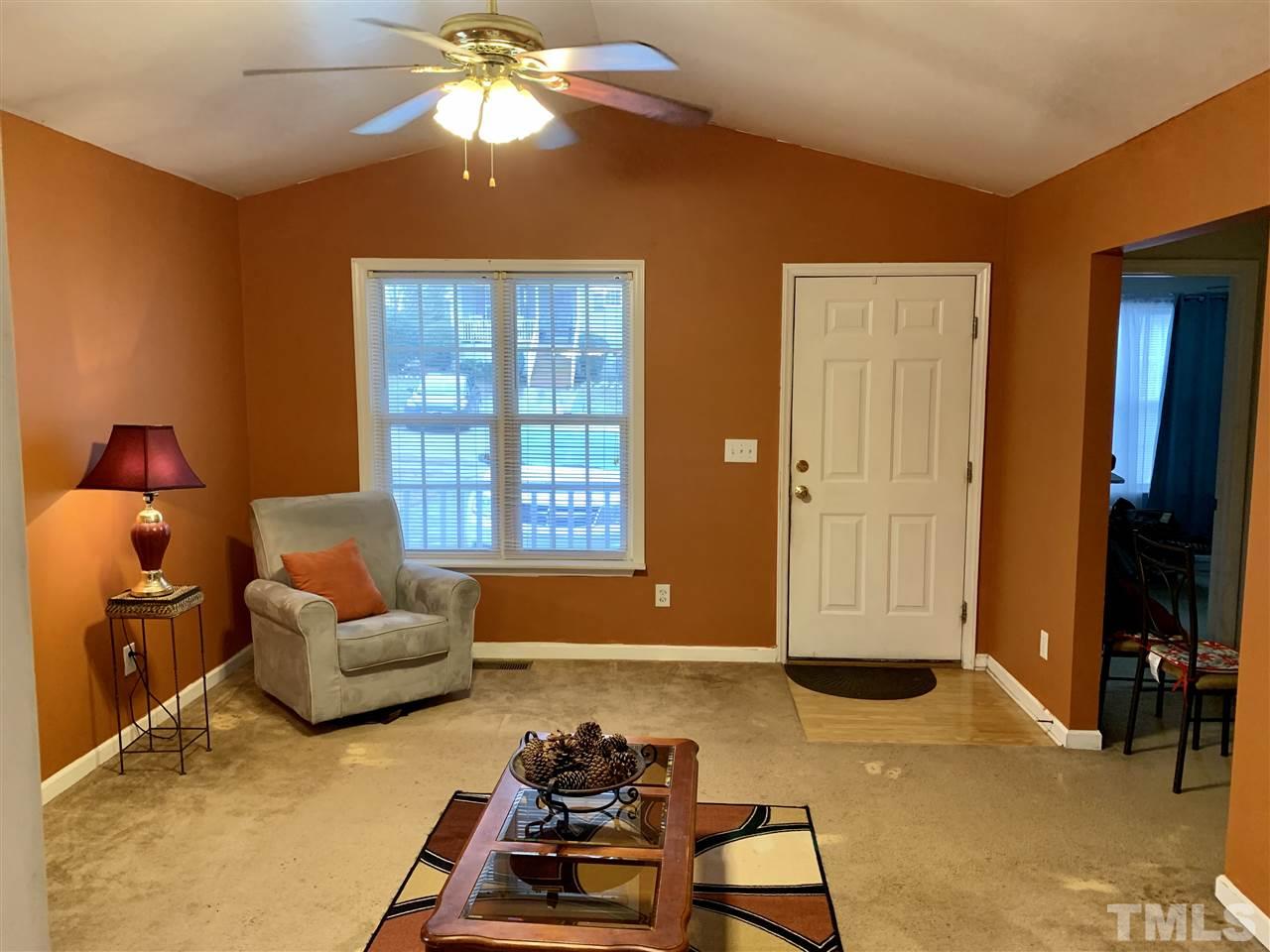 1117 Thelonious Drive Raleigh, NC 27610 - Photo 6 of 25 a living room with furniture and a flat screen tv