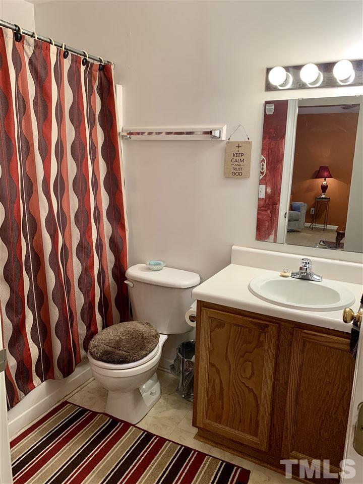 1117 Thelonious Drive Raleigh, NC 27610 - Photo 7 of 25 a bathroom with a sink and a mirror
