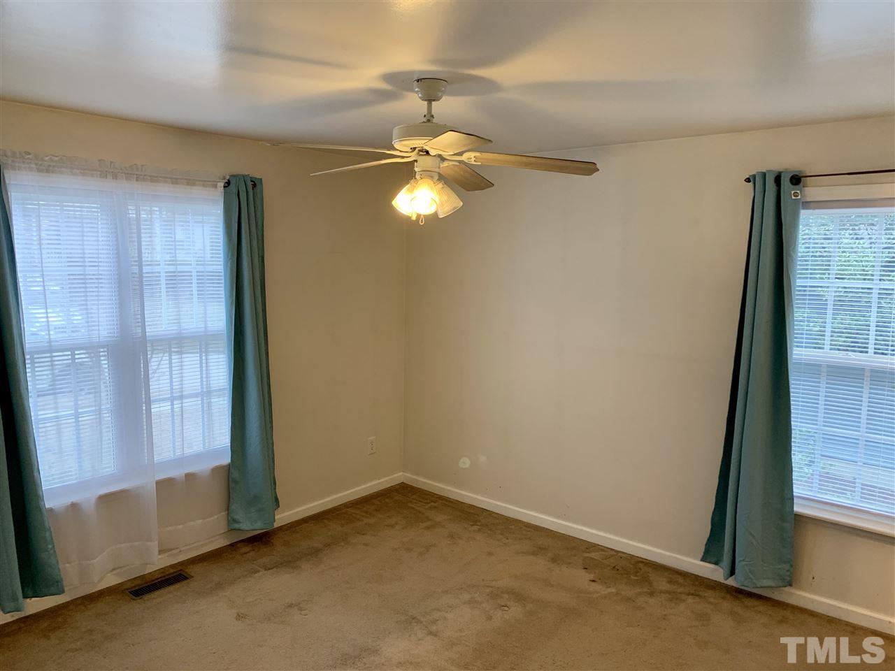 1117 Thelonious Drive Raleigh, NC 27610 - Photo 8 of 25 an empty room with windows and fan