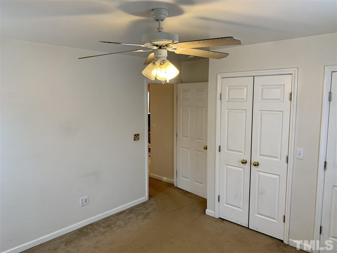 1117 Thelonious Drive Raleigh, NC 27610 - Photo 10 of 25 an empty room with a chandelier fan and a chandelier fan