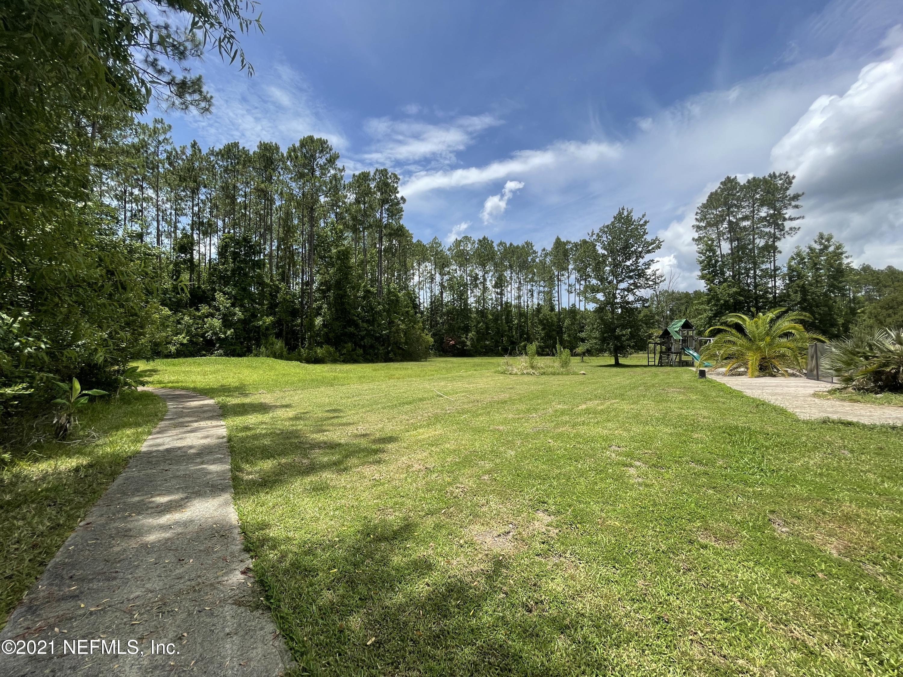 127 Foxcraft Street St. Augustine, FL 32092 - Photo 11 of 77 a view of a field with a tree in the background