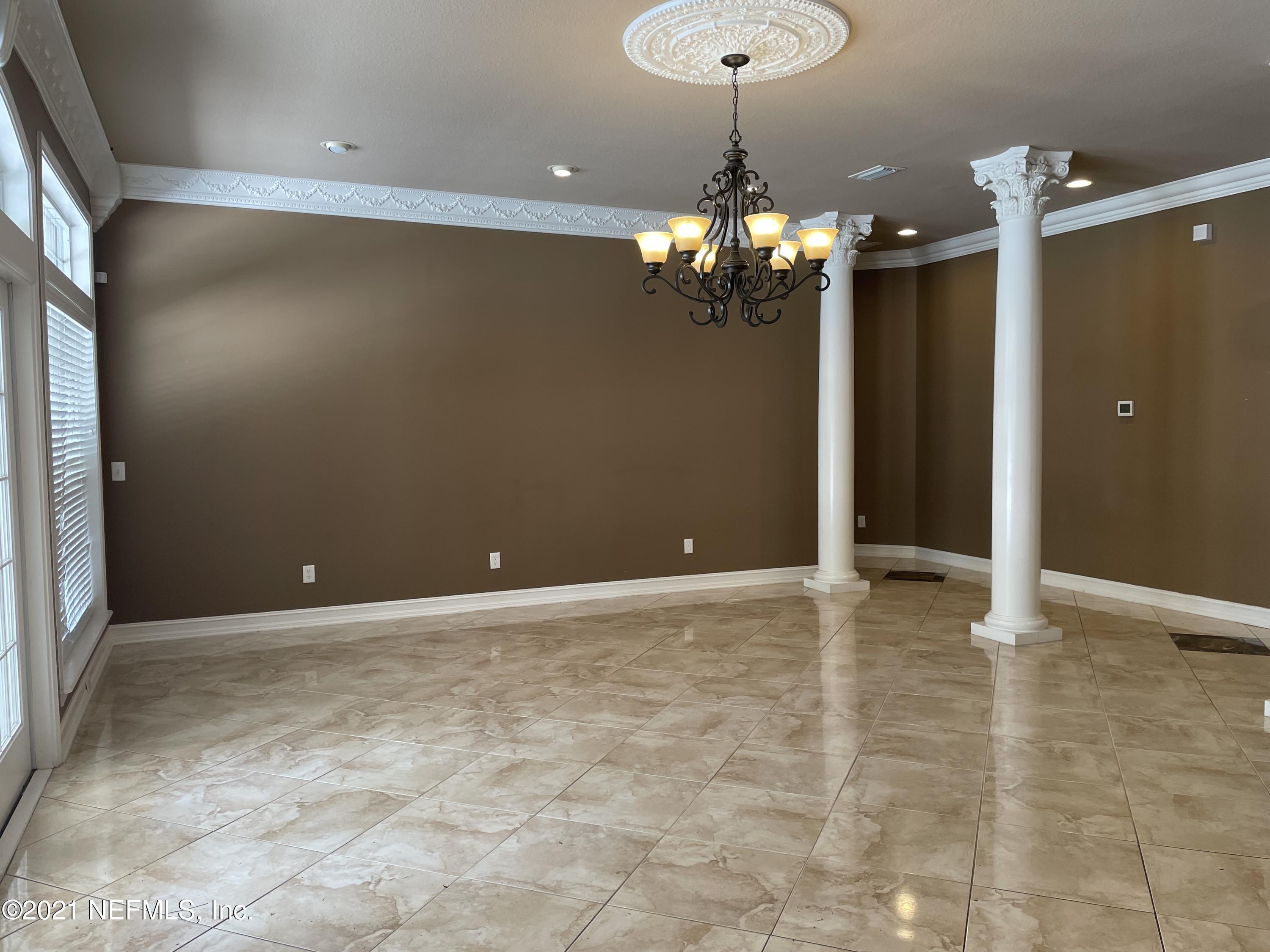 127 Foxcraft Street St. Augustine, FL 32092 - Photo 32 of 77 a view of a livingroom with a chandelier fan and kitchen view