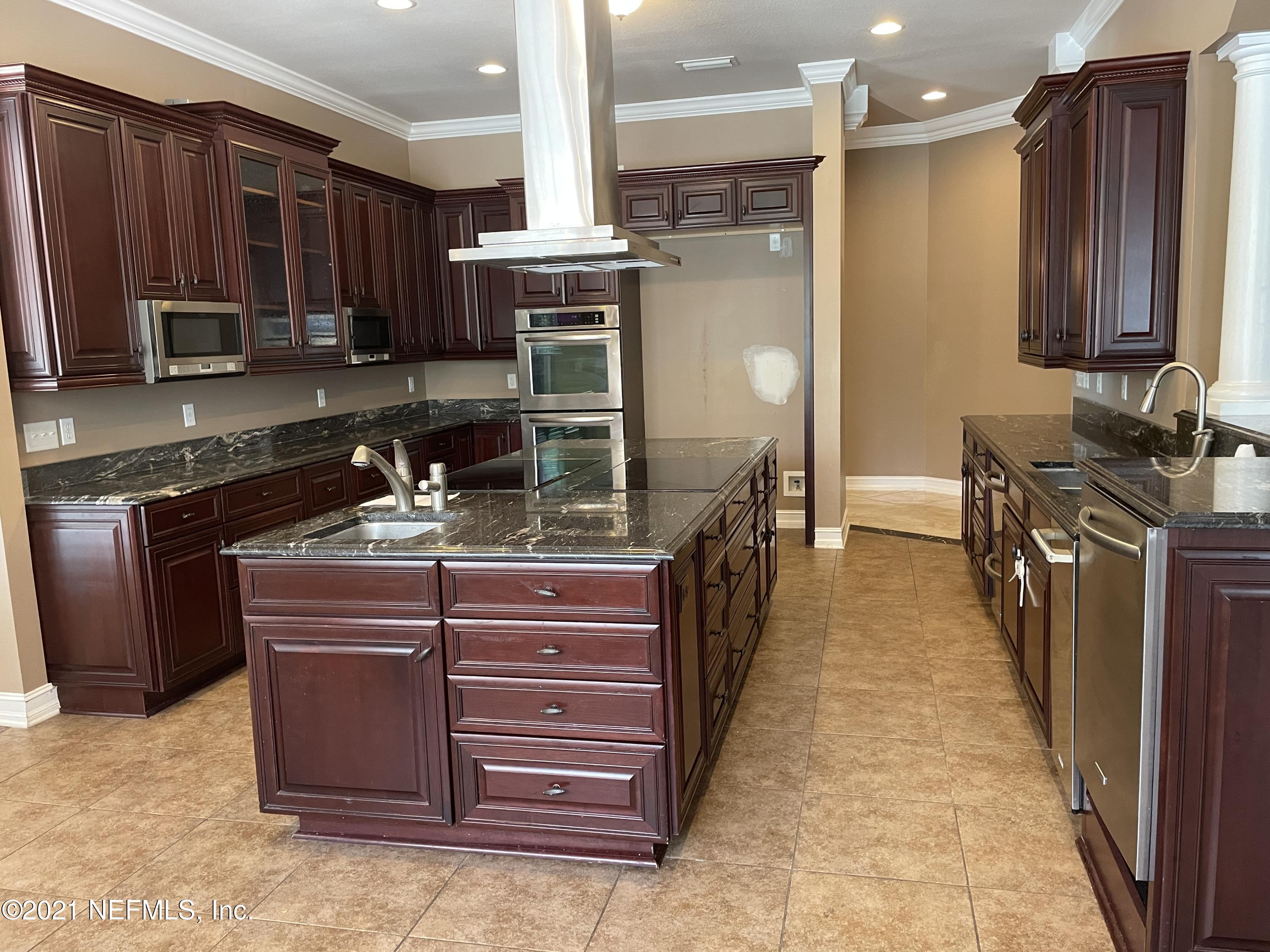 127 Foxcraft Street St. Augustine, FL 32092 - Photo 44 of 77 a kitchen with stainless steel appliances granite countertop a stove refrigerator and cabinets