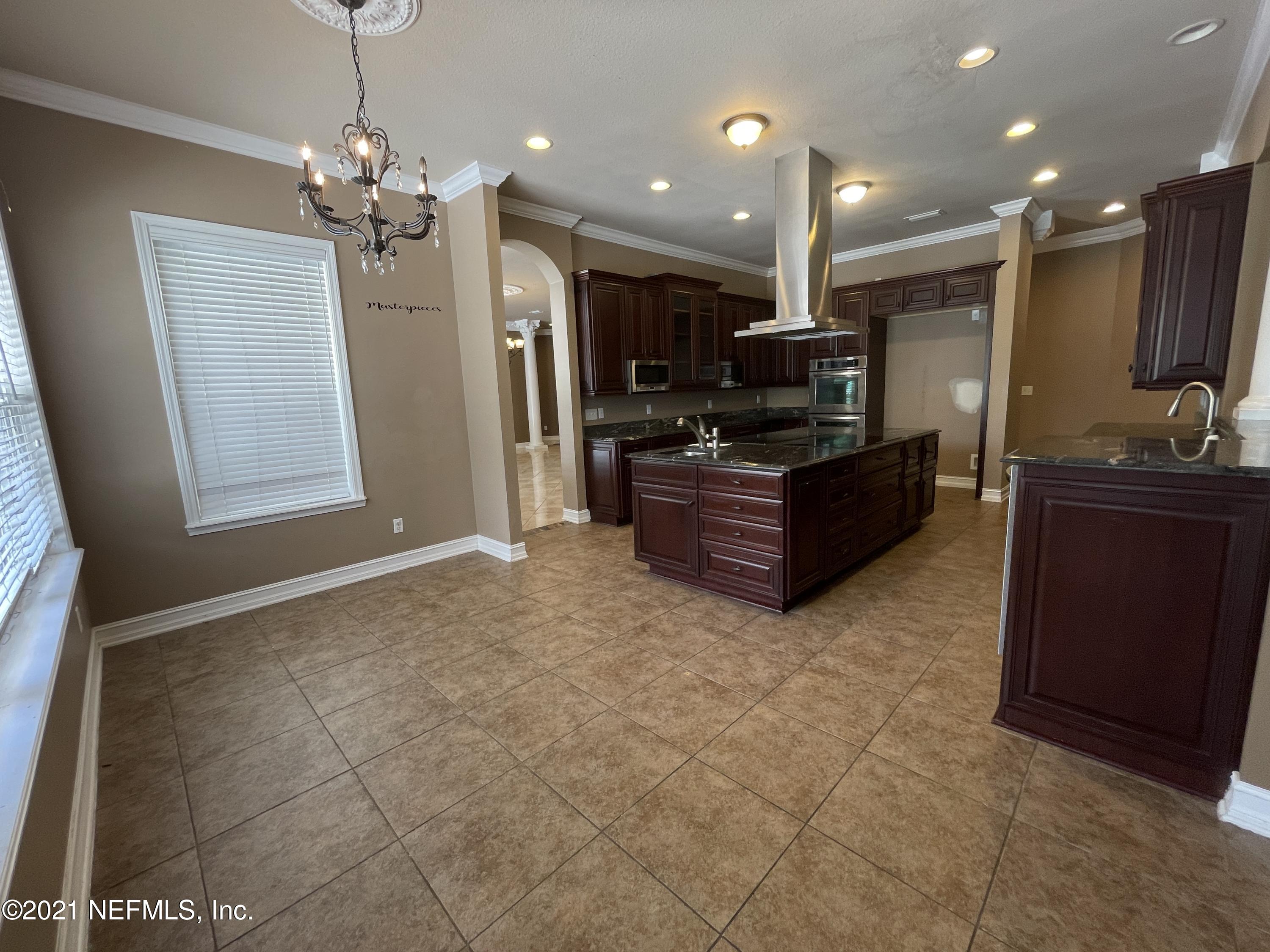 127 Foxcraft Street St. Augustine, FL 32092 - Photo 47 of 77 a living room with kitchen island granite countertop furniture and a flat screen tv
