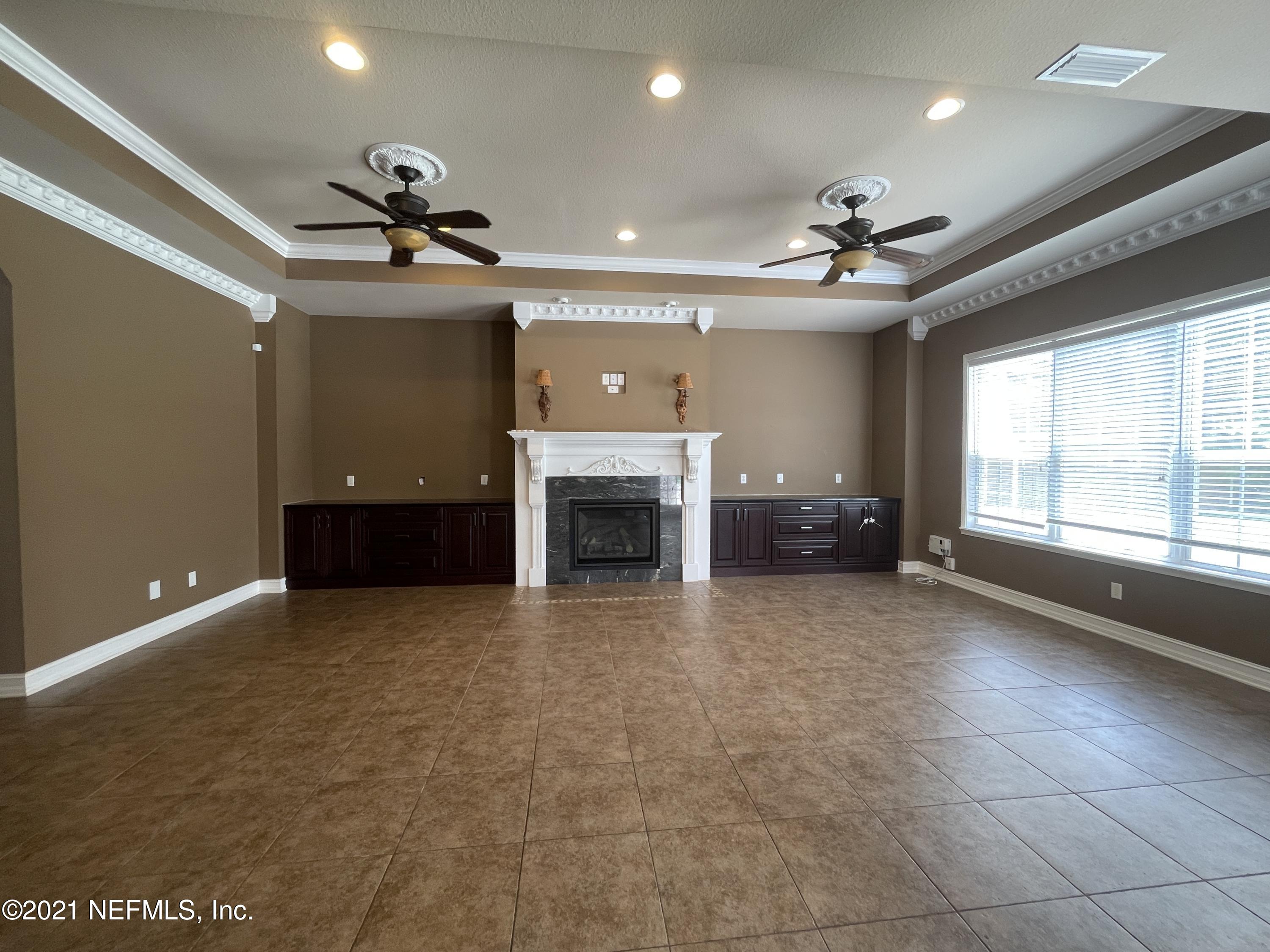 127 Foxcraft Street St. Augustine, FL 32092 - Photo 49 of 77 a view of an empty room with a fireplace and a window