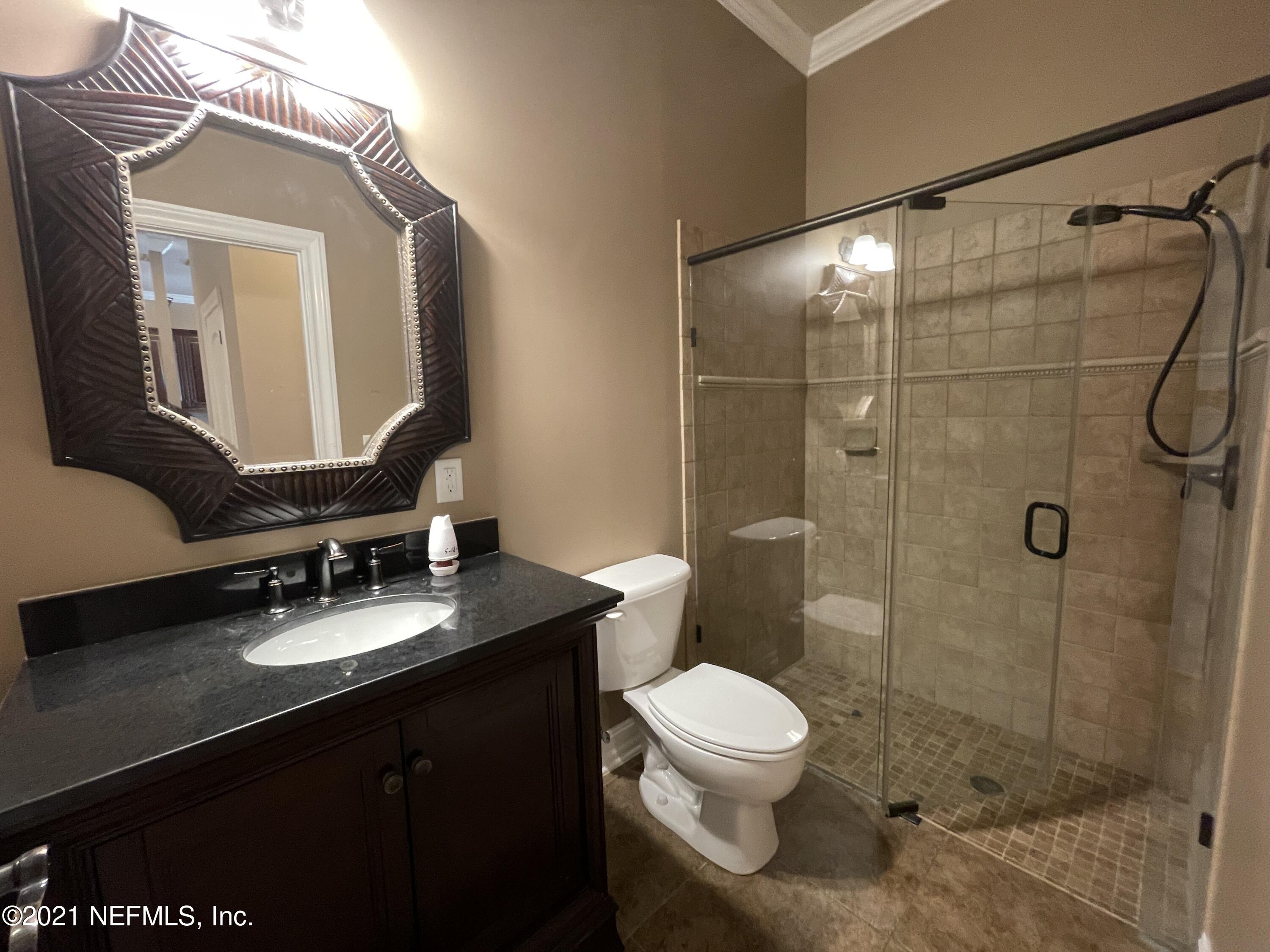 127 Foxcraft Street St. Augustine, FL 32092 - Photo 52 of 77 a bathroom with a granite countertop sink toilet a mirror and shower