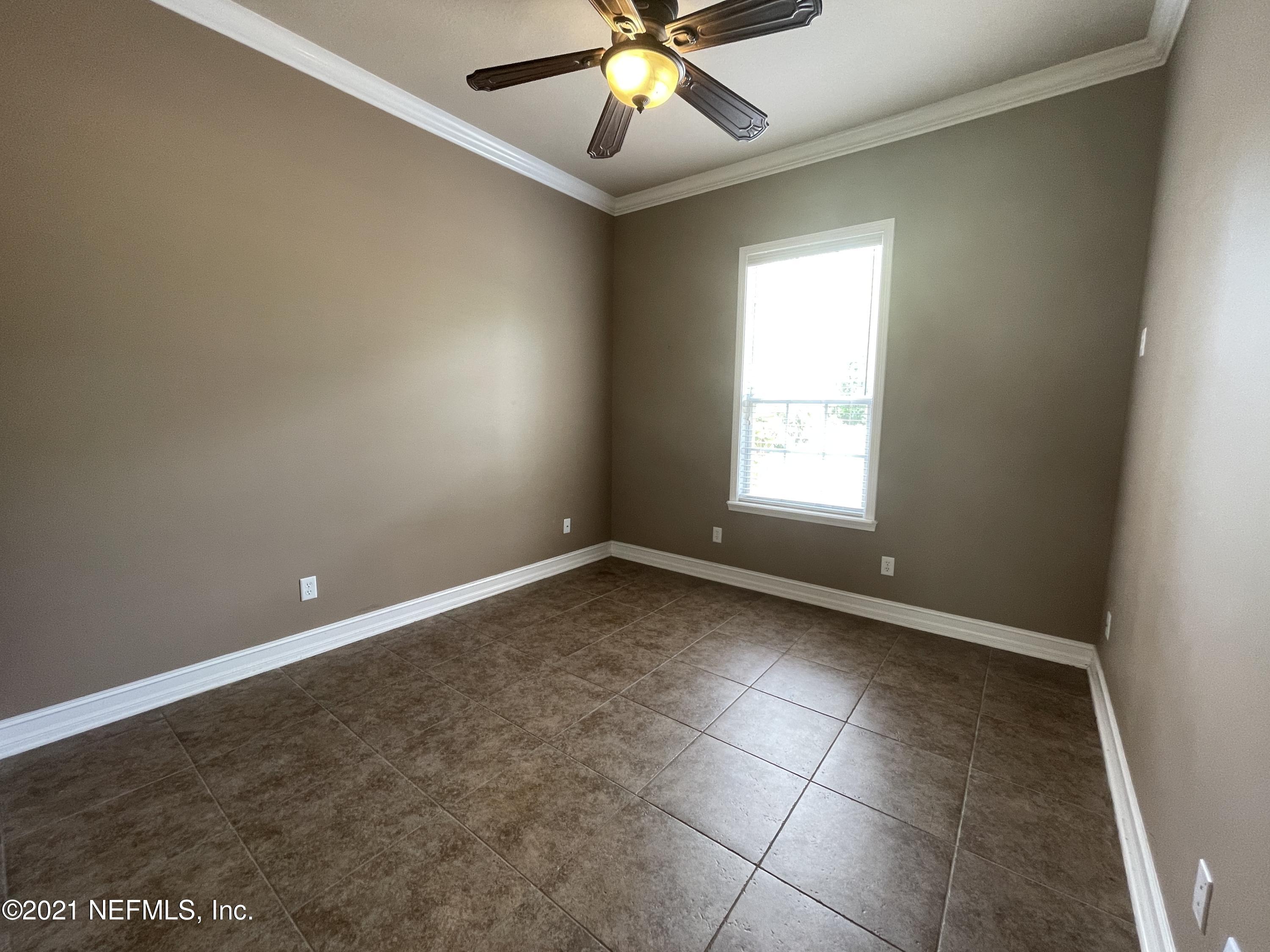 127 Foxcraft Street St. Augustine, FL 32092 - Photo 53 of 77 a view of an empty room with window and chandelier fan