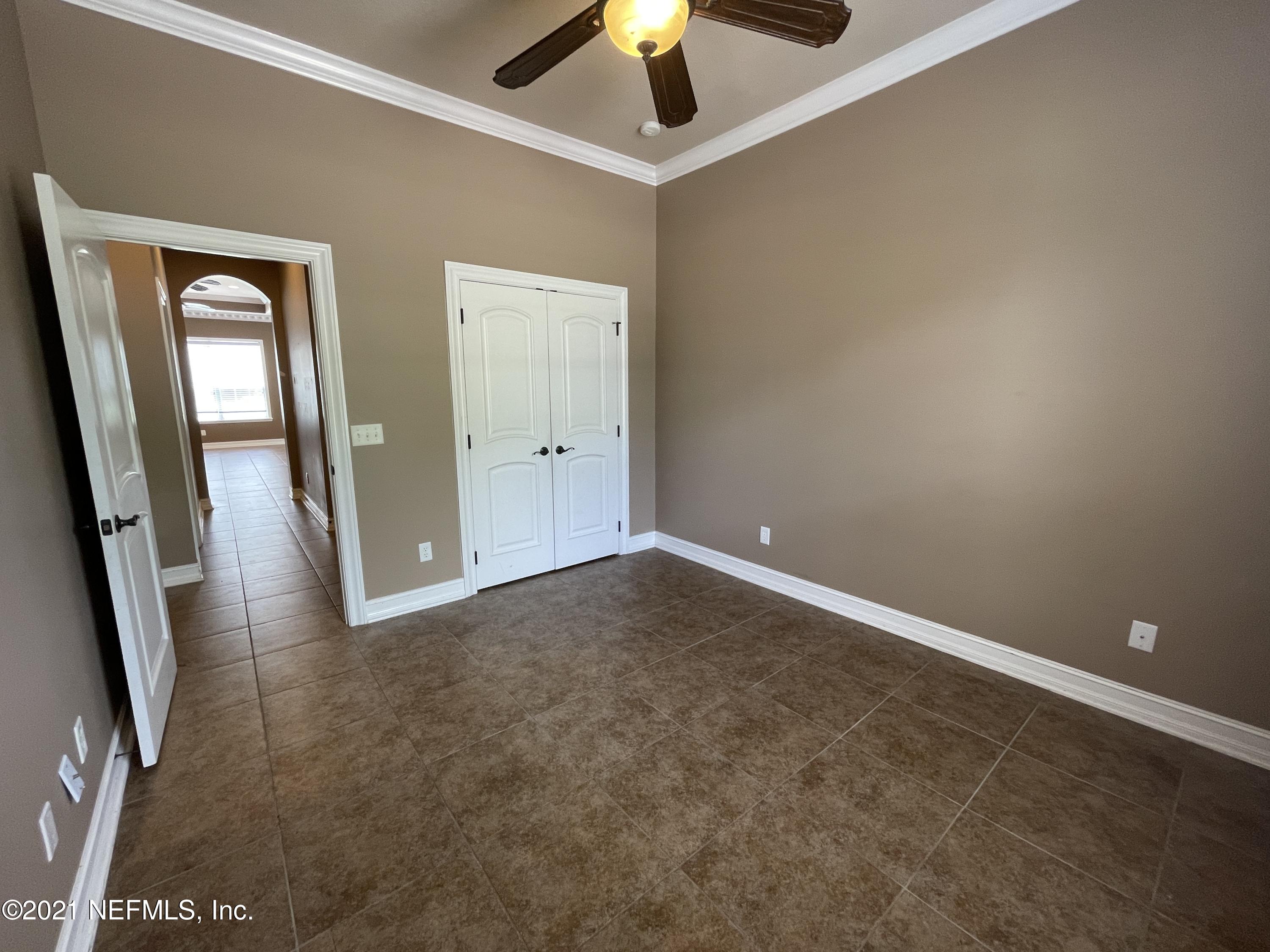 127 Foxcraft Street St. Augustine, FL 32092 - Photo 54 of 77 an empty room with a ceiling fan and window