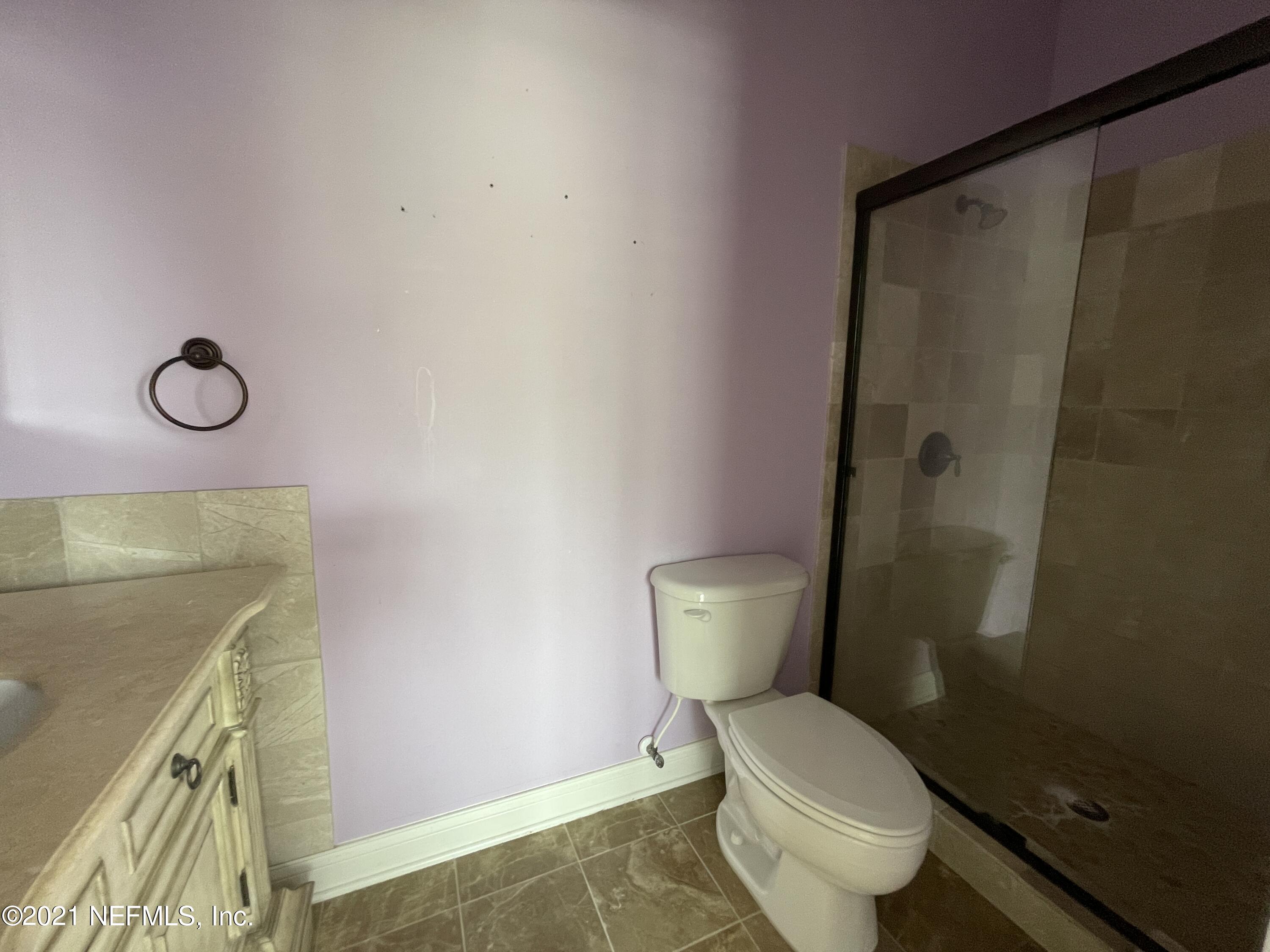 127 Foxcraft Street St. Augustine, FL 32092 - Photo 69 of 77 a white toilet sitting next to a bathroom sink and vanity